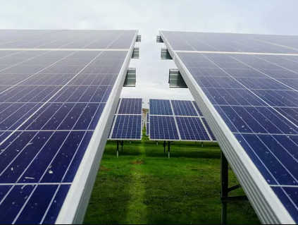 Solar panels installed on a vast field, harnessing sunlight for renewable energy generation.
